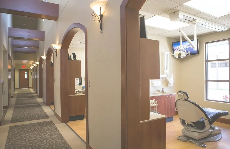 The corridor to the treatment rooms, with arched doorways and wall sconces.